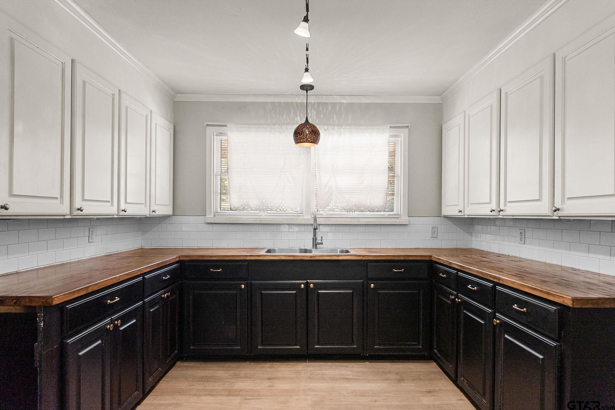 150 Wightman Lane Rusk, TX 75785 - Photo 10 of 38 a kitchen with stainless steel appliances granite countertop a sink and dishwasher with wooden cabinets