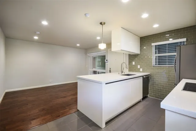 a kitchen that has a sink and a stove