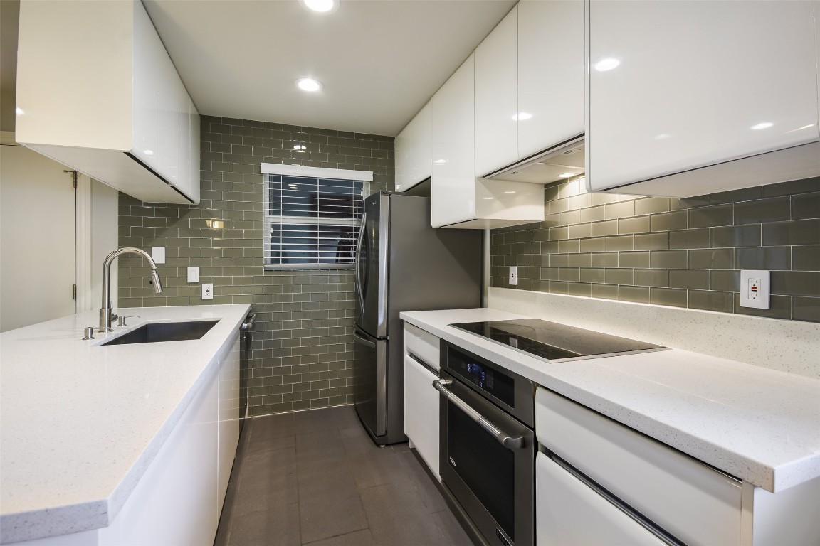 3110 Red River Street, Unit 201 Austin, TX 78705 - Photo 12 of 30 a kitchen that has a sink and a stove
