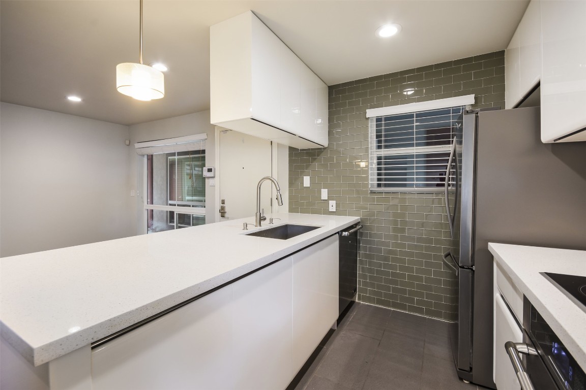 3110 Red River Street, Unit 201 Austin, TX 78705 - Photo 13 of 30 a kitchen with a stove and a sink