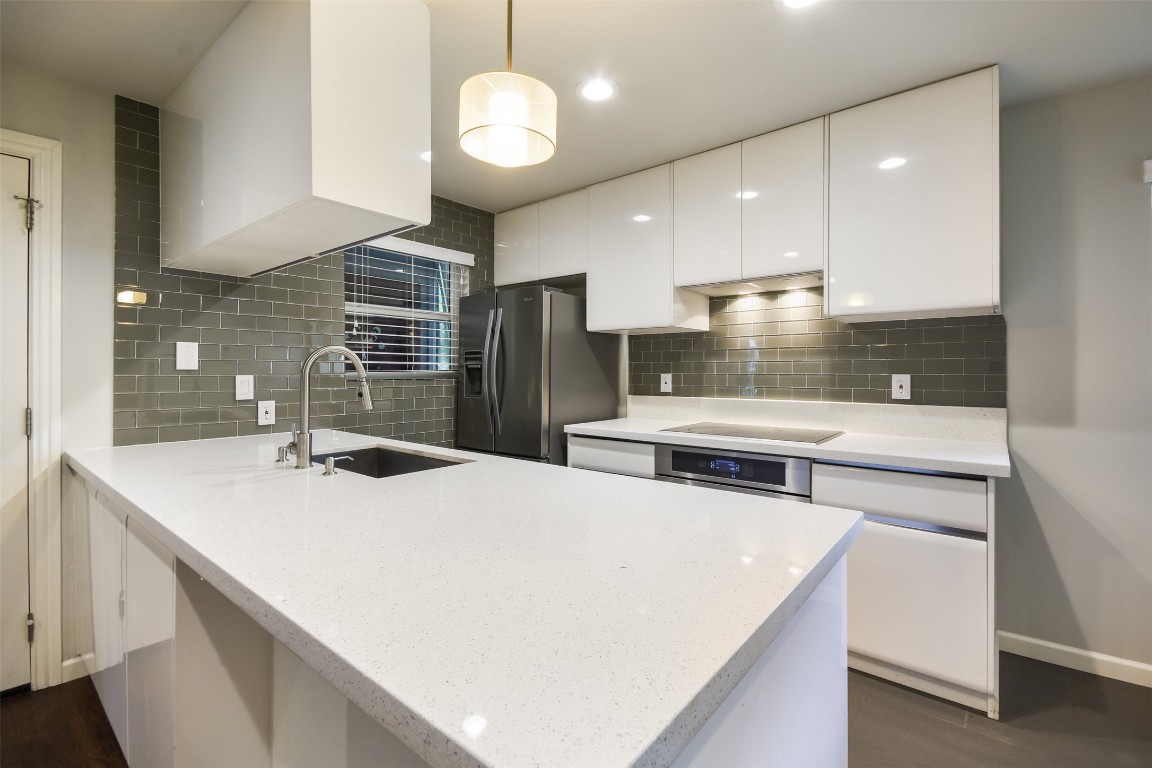 3110 Red River Street, Unit 201 Austin, TX 78705 - Photo 14 of 30 a kitchen with stainless steel appliances a sink a stove a refrigerator and cabinets