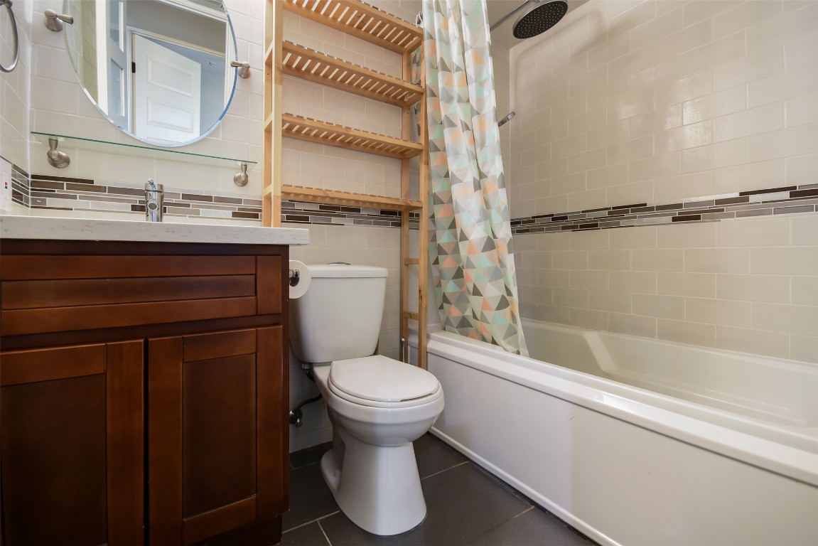 3110 Red River Street, Unit 201 Austin, TX 78705 - Photo 22 of 30 a bathroom with a sink and a mirror