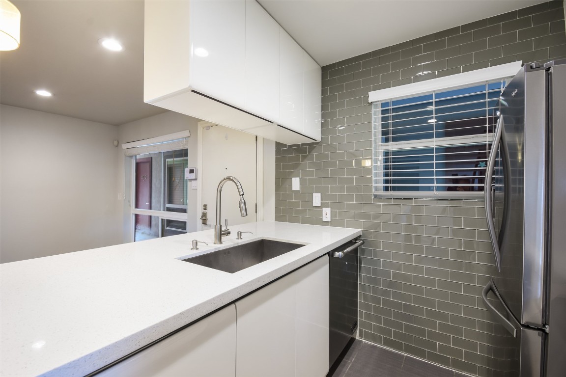 3110 Red River Street, Unit 201 Austin, TX 78705 - Photo 25 of 30 a kitchen with a sink and a refrigerator