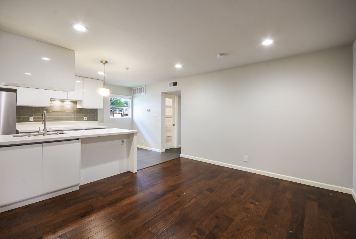 3110 Red River Street, Unit 201 Austin, TX 78705 - Photo 7 of 30 a large kitchen with hardwood floor and a sink