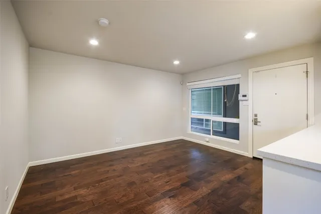 a kitchen that has a sink a stove and a wooden floor