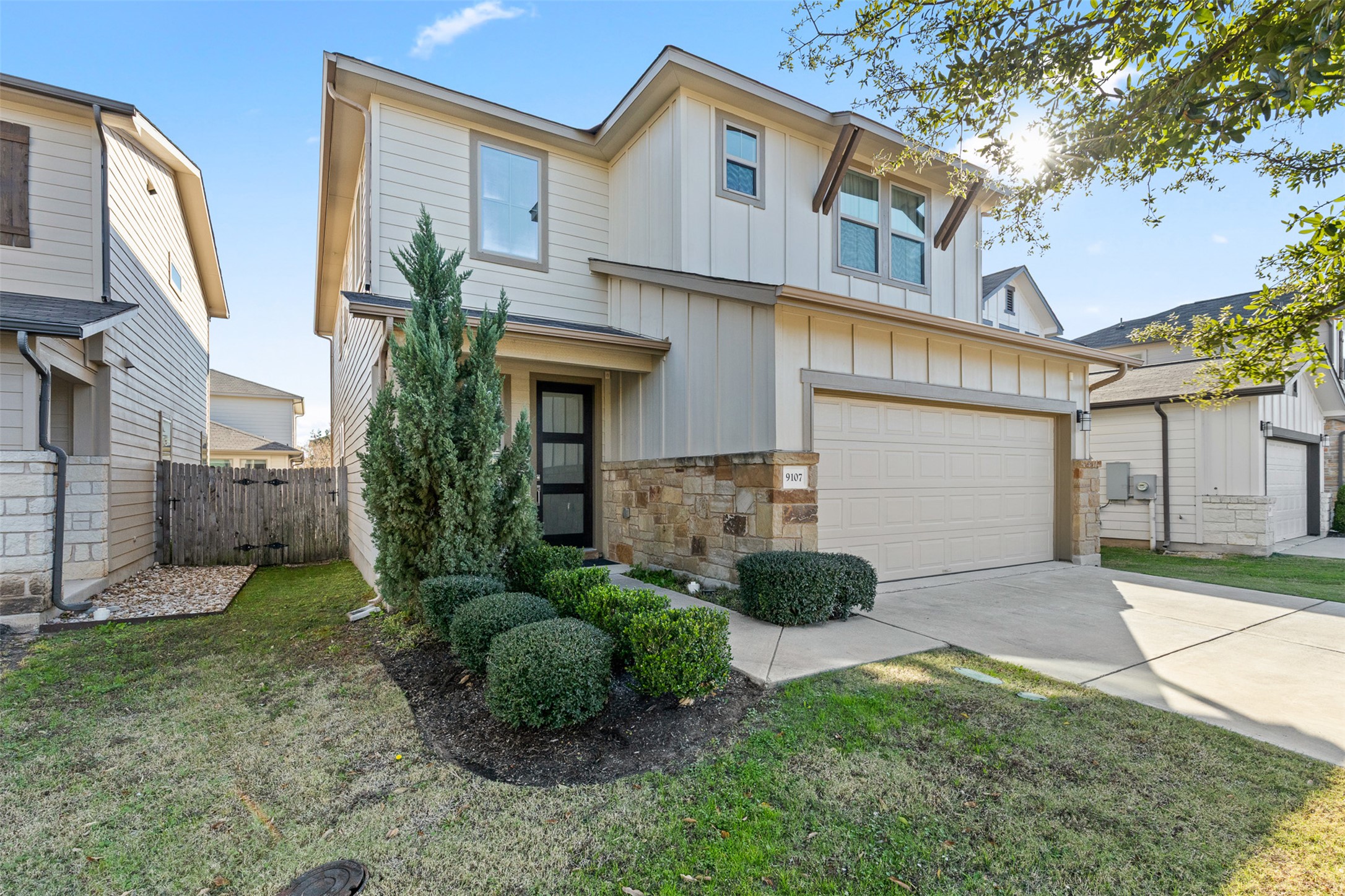 View of front of house with an attached garage and concrete driveway