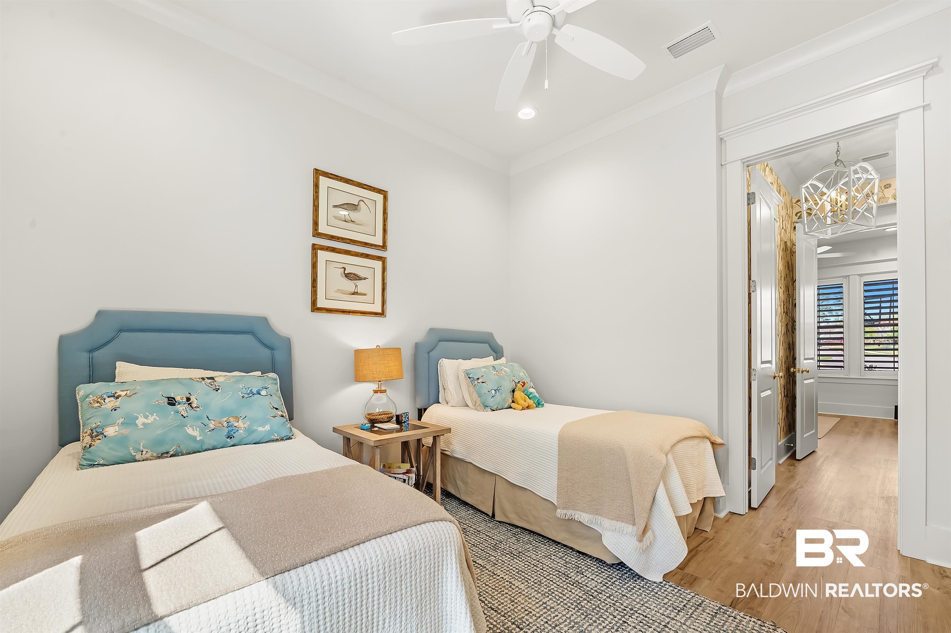 27888 Oakachoy Loop Daphne, AL 36526 - Photo 35 of 65 Bedroom featuring ceiling fan with notable chandelier, visible vents, crown molding, and wood finished floors
