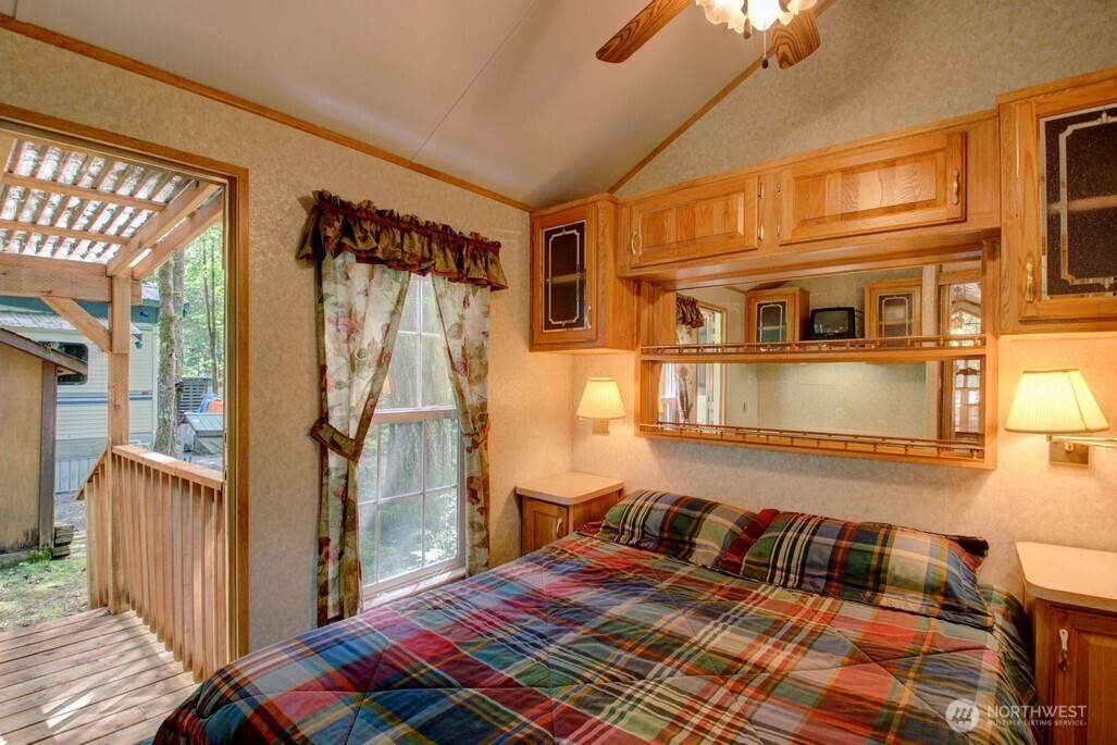 134 Drial Loop Maple Falls, WA 98266 - Photo 15 of 36 a bedroom with a bed and a chandelier