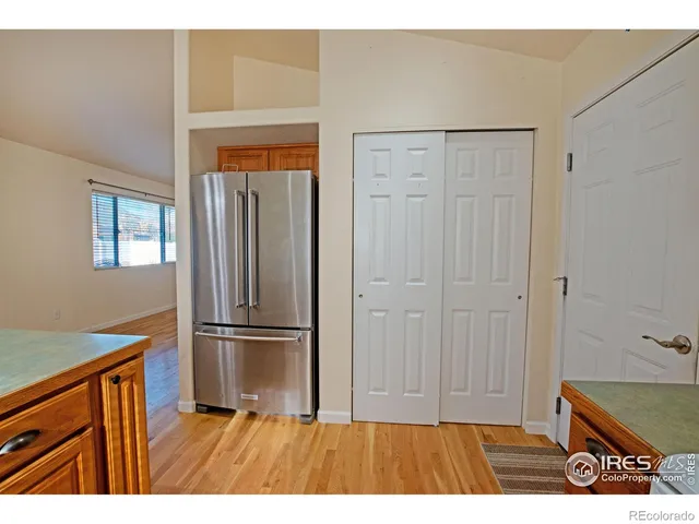 a room with a refrigerator and window