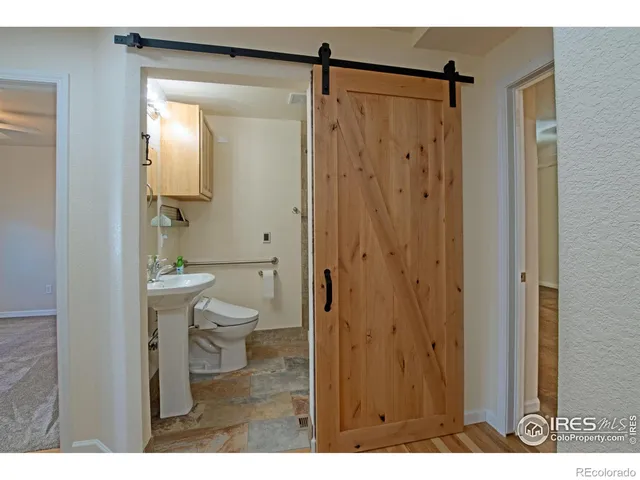 a bathroom with a shower a toilet and a sink