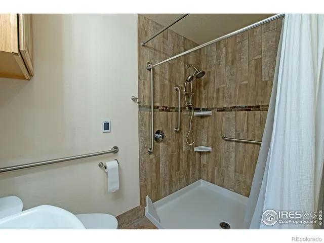 a bathroom with a shower and a glass door