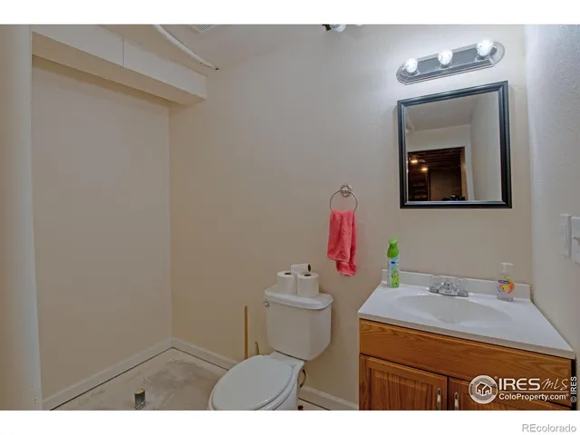 a bathroom with a sink toilet and mirror