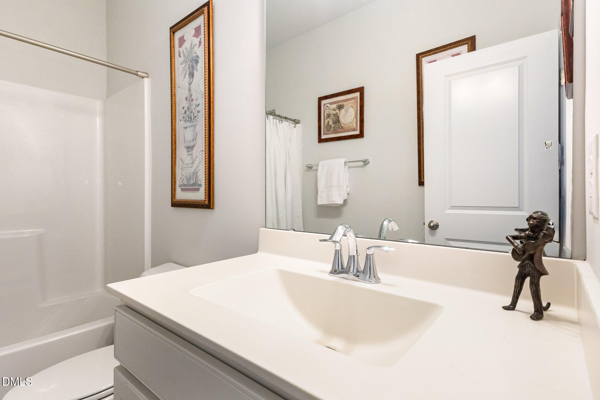 2906 Great Lawn Road Apex, NC 27502 - Photo 18 of 41 a bathroom with a sink vanity and a mirror