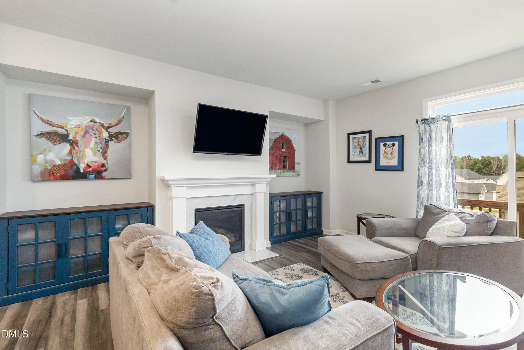 2906 Great Lawn Road Apex, NC 27502 - Photo 2 of 41 a living room with furniture a fireplace and a flat screen tv
