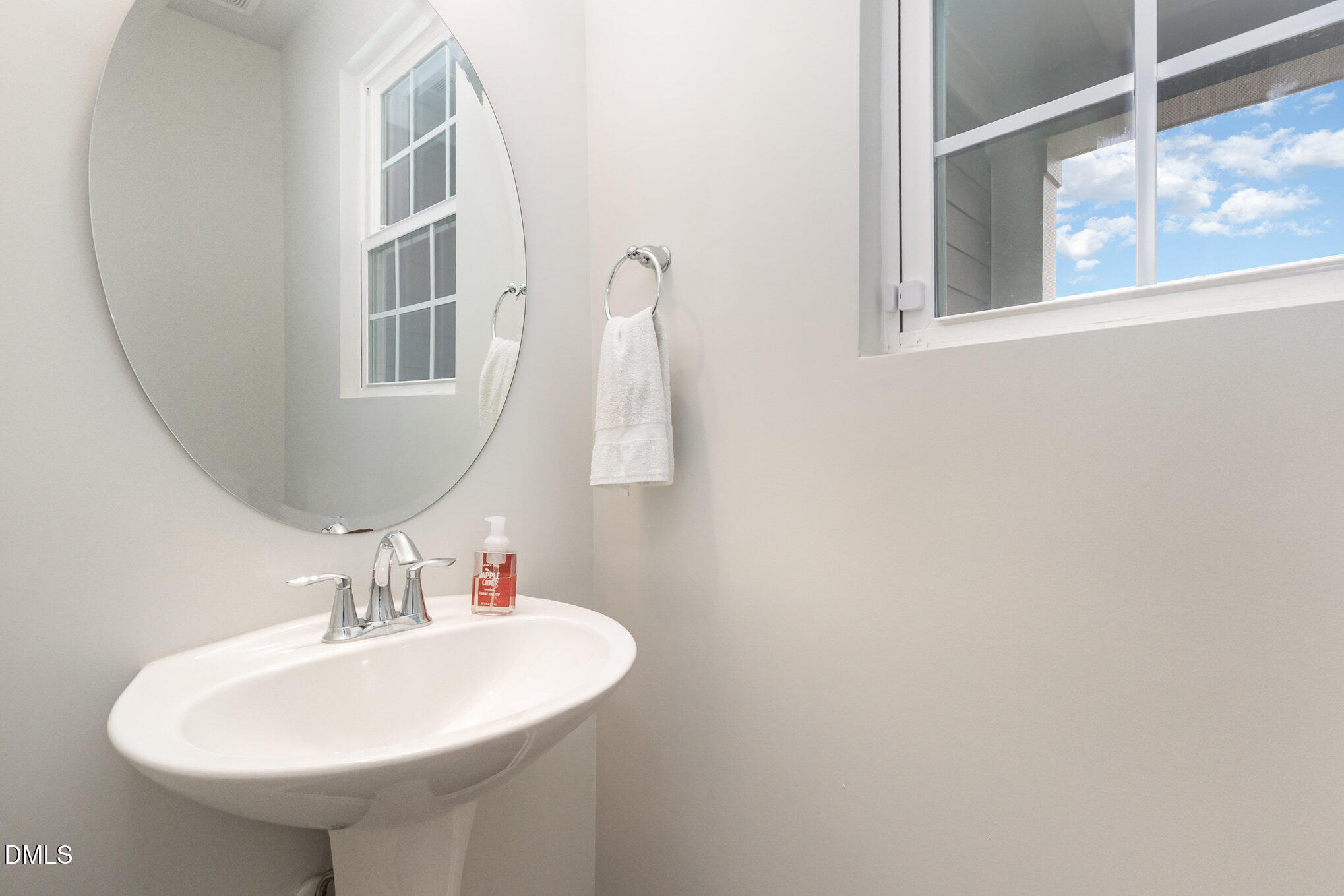 2906 Great Lawn Road Apex, NC 27502 - Photo 21 of 41 a bathroom with a sink and a mirror