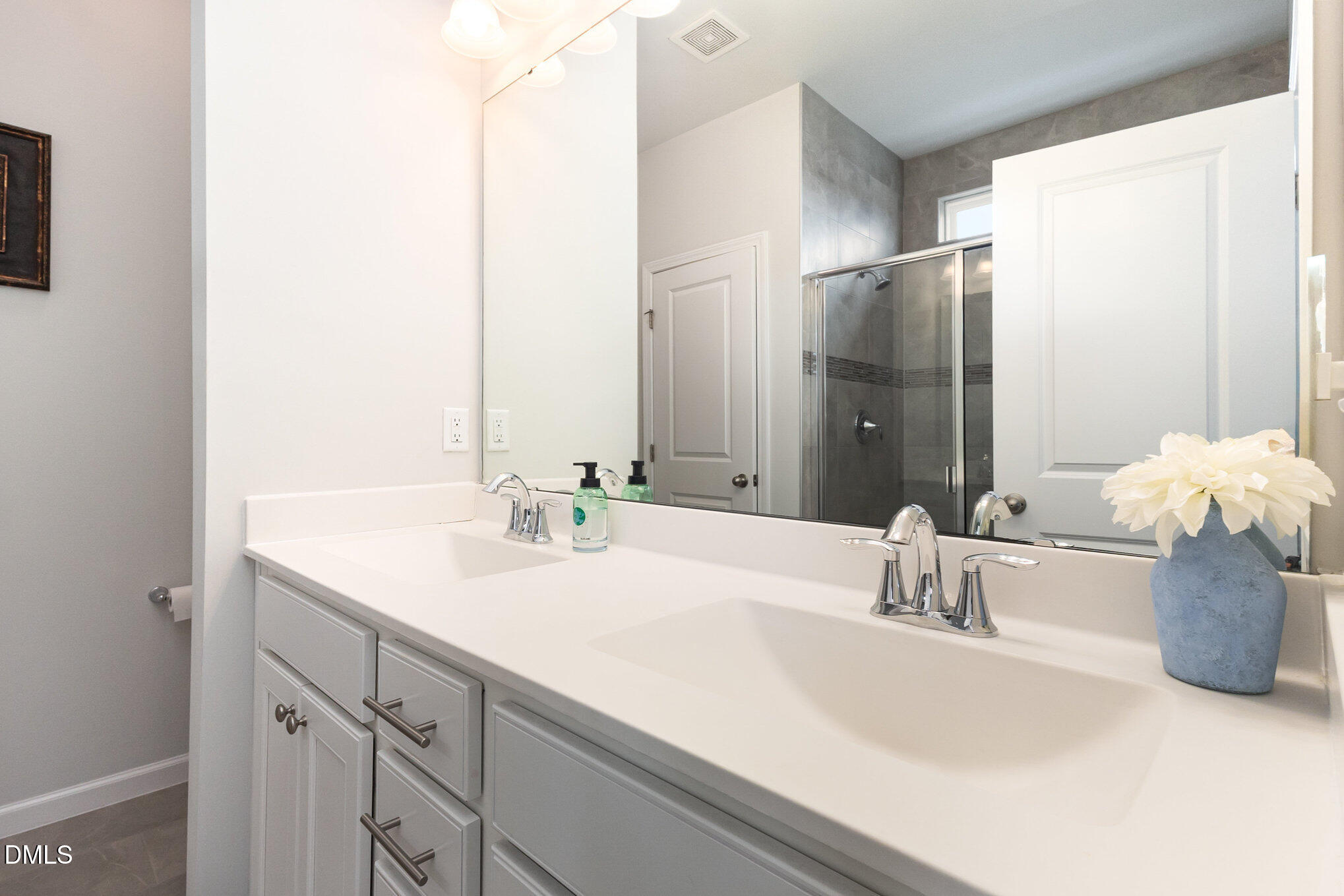 2906 Great Lawn Road Apex, NC 27502 - Photo 24 of 41 a bathroom with a sink and a mirror