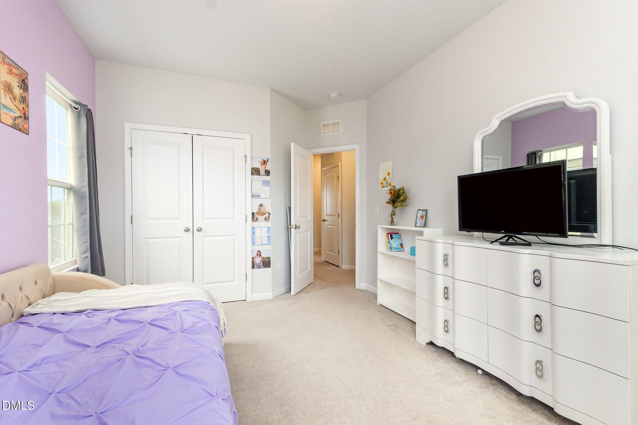 2906 Great Lawn Road Apex, NC 27502 - Photo 28 of 41 a hotel room with a bed and flat screen tv