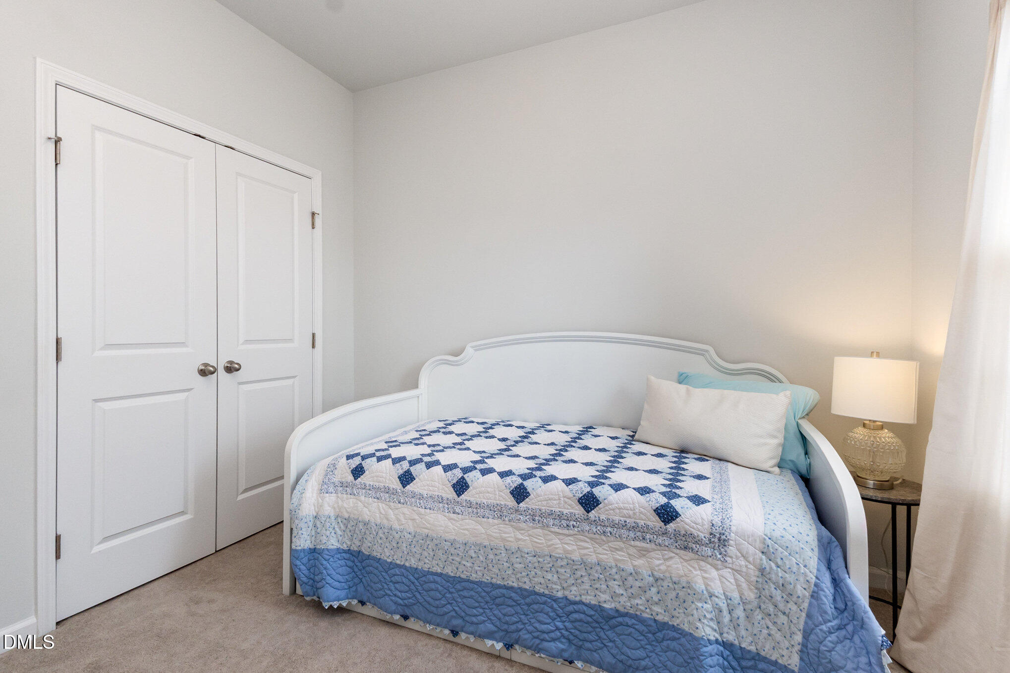 2906 Great Lawn Road Apex, NC 27502 - Photo 30 of 41 a bedroom with a bed and a mirror