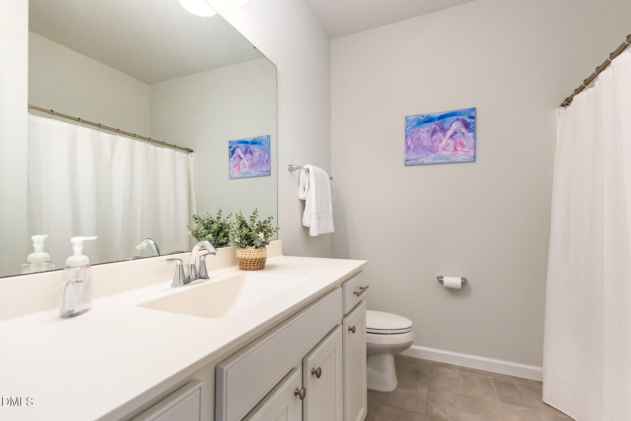 2906 Great Lawn Road Apex, NC 27502 - Photo 31 of 41 a bathroom with a granite countertop sink a toilet and a large mirror