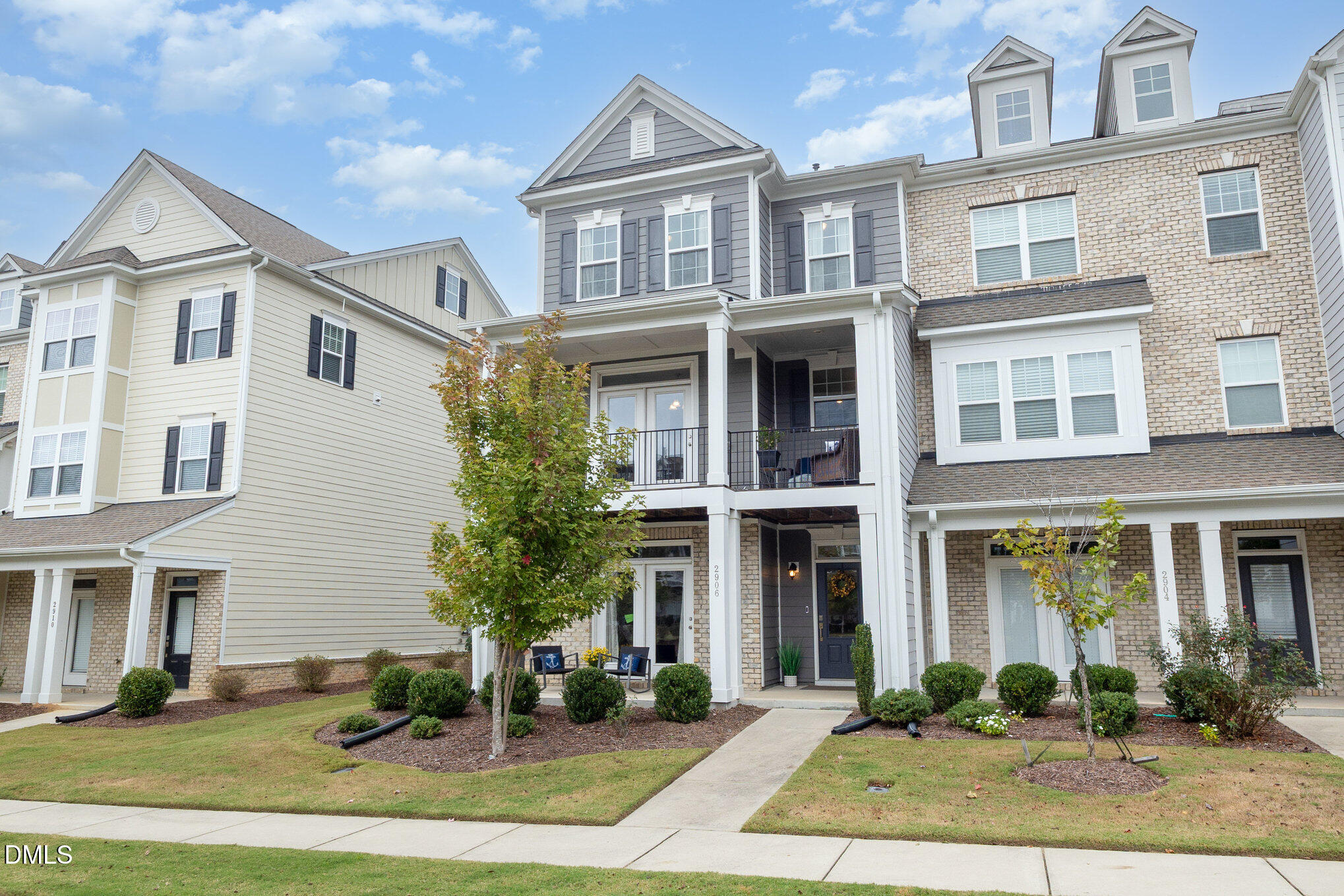 2906 Great Lawn Road Apex, NC 27502 - Photo 35 of 41 a front view of a residential apartment building with a yard