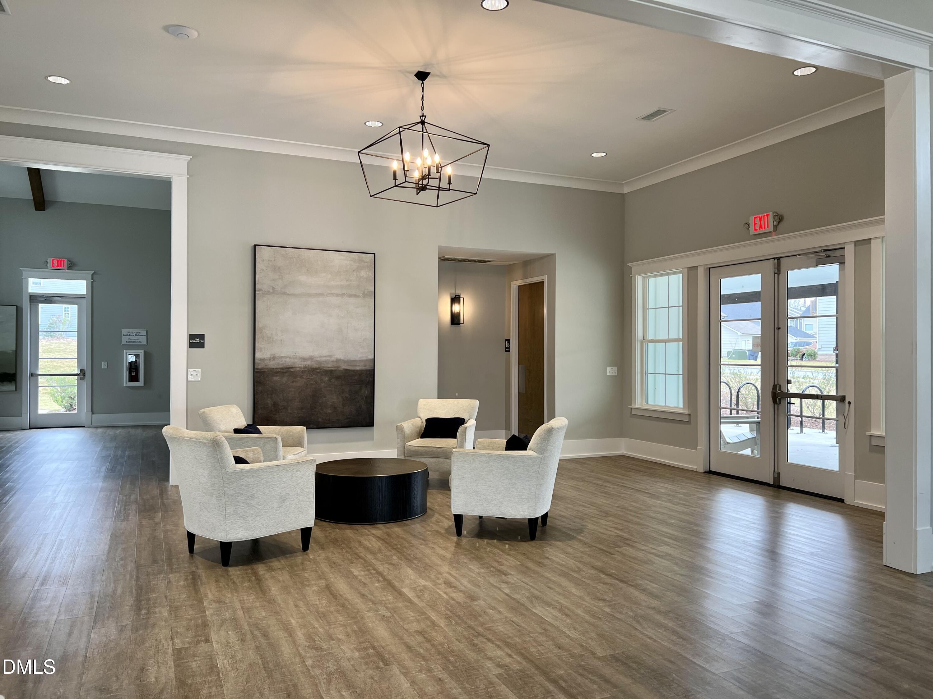 2906 Great Lawn Road Apex, NC 27502 - Photo 38 of 41 a living room with furniture wooden floor and a chandelier