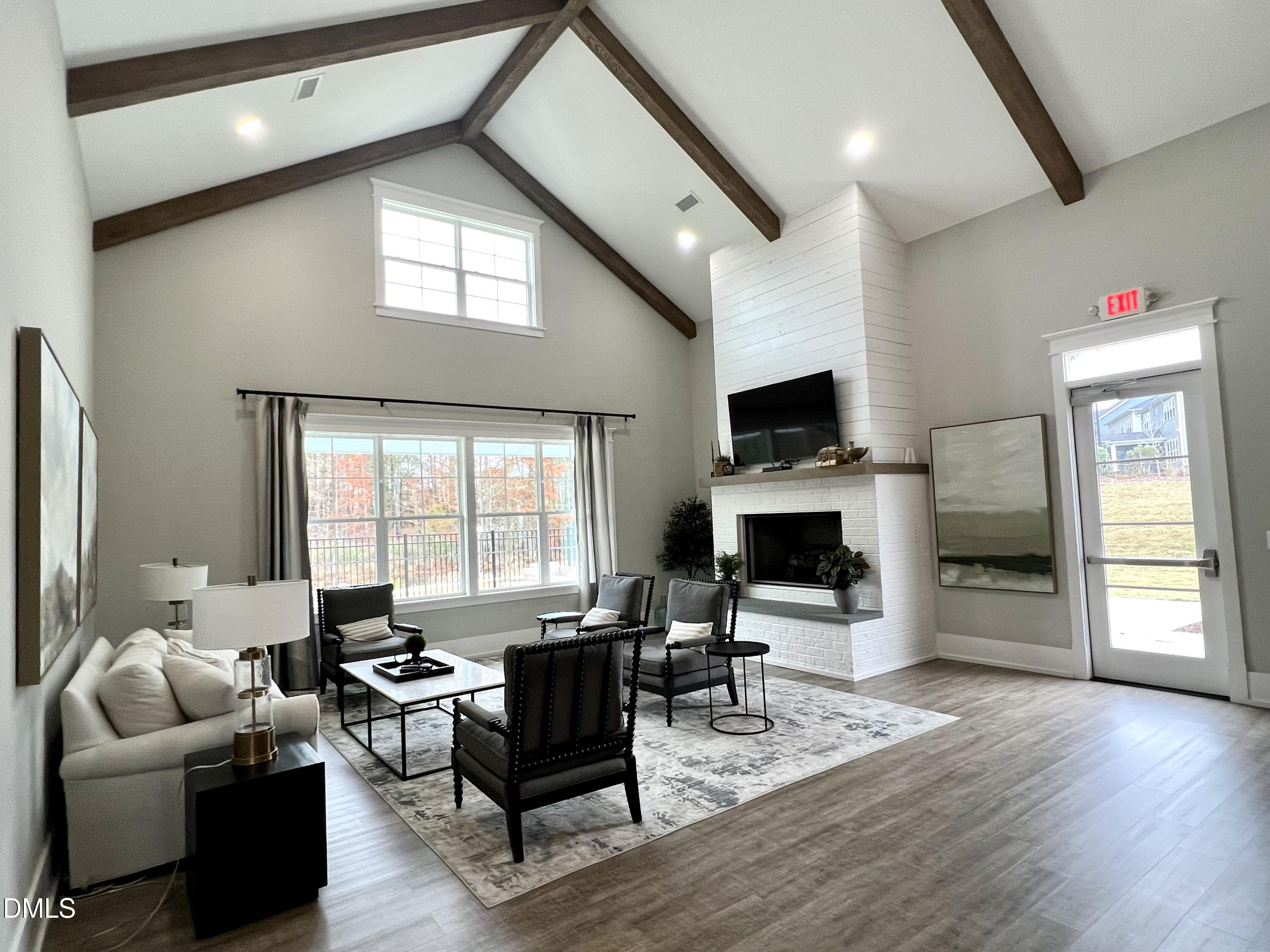 2906 Great Lawn Road Apex, NC 27502 - Photo 39 of 41 a living room with furniture a fireplace and a flat screen tv