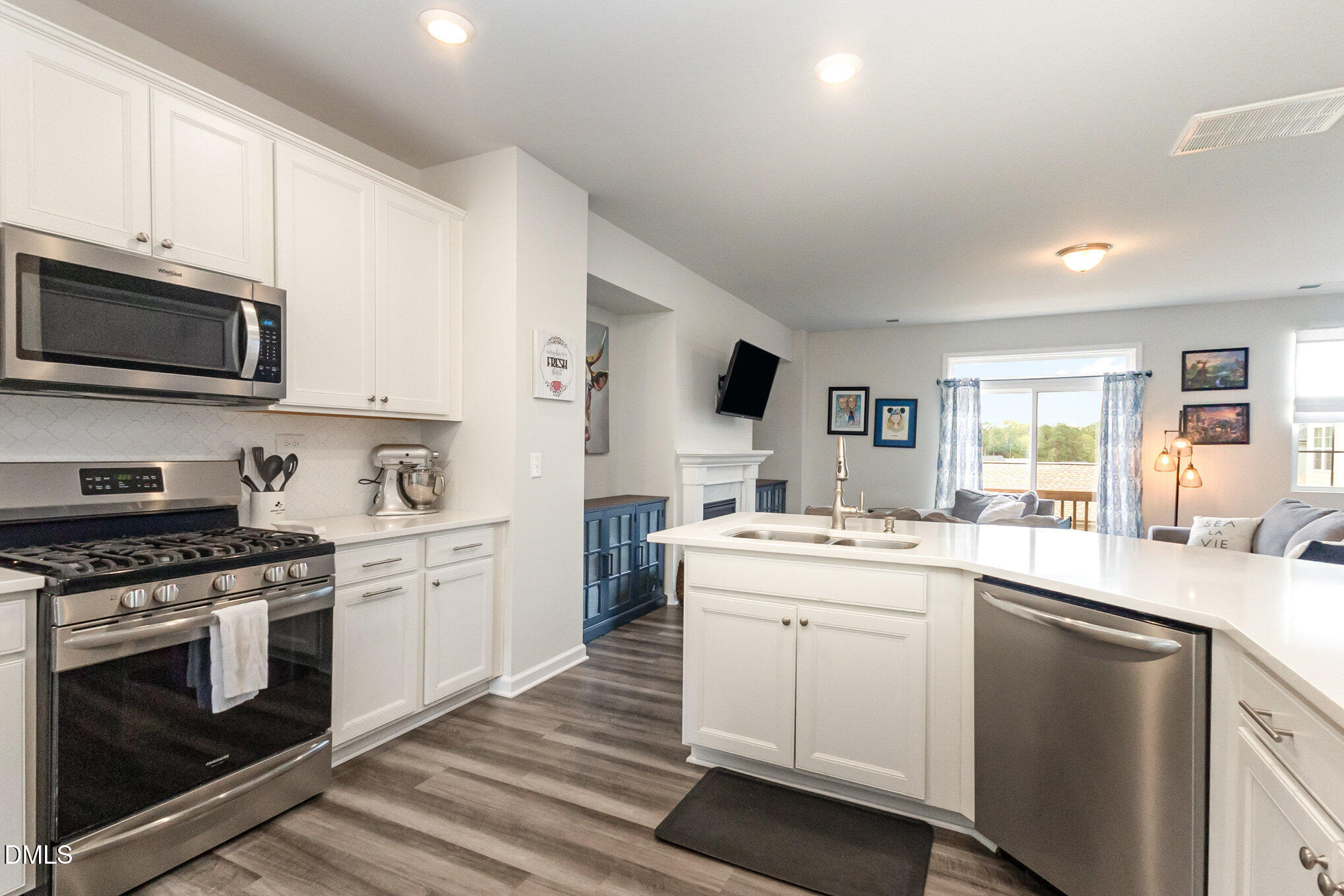 2906 Great Lawn Road Apex, NC 27502 - Photo 4 of 41 a kitchen with stainless steel appliances granite countertop a stove sink and cabinets