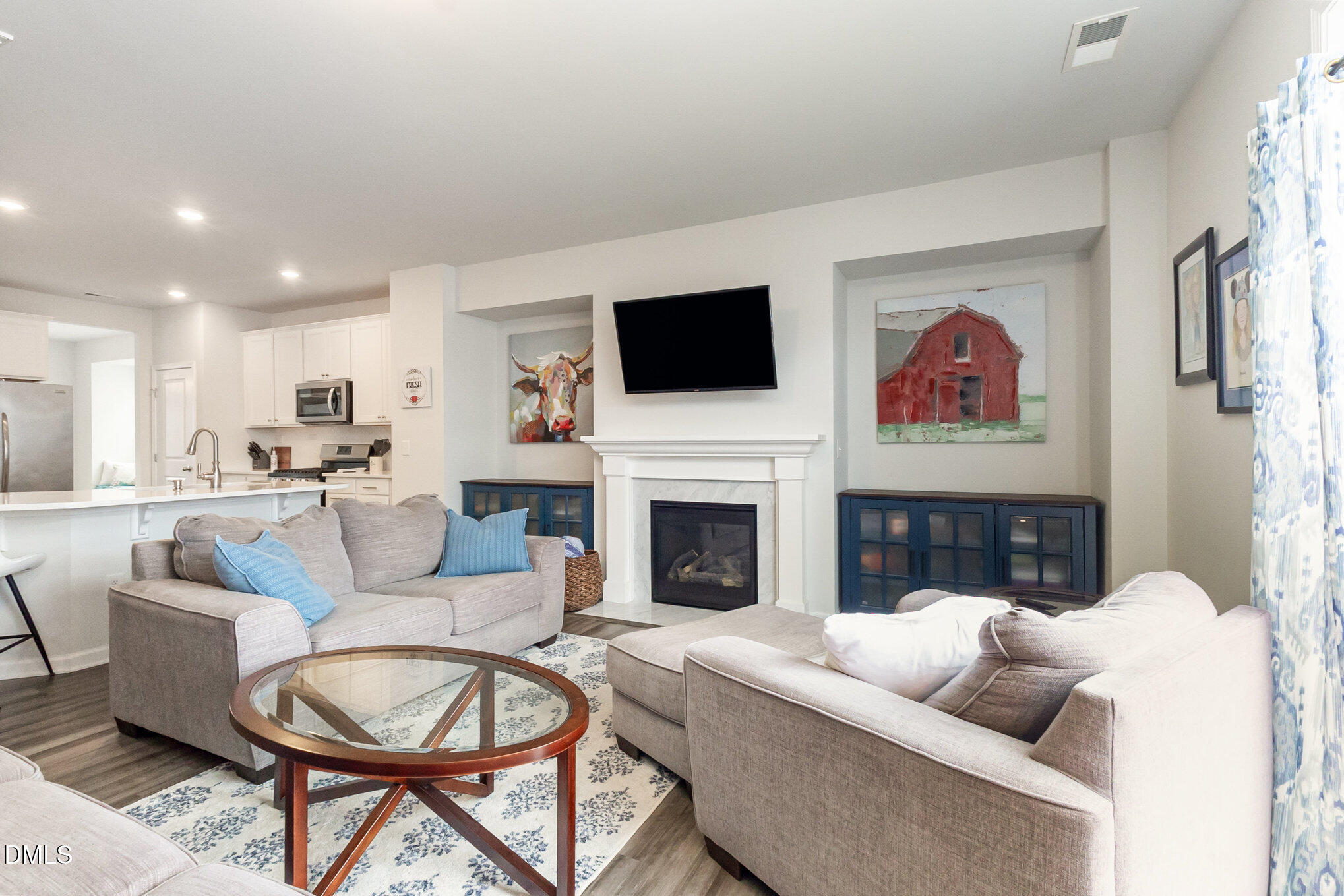 2906 Great Lawn Road Apex, NC 27502 - Photo 7 of 41 a living room with fireplace furniture and a flat screen tv