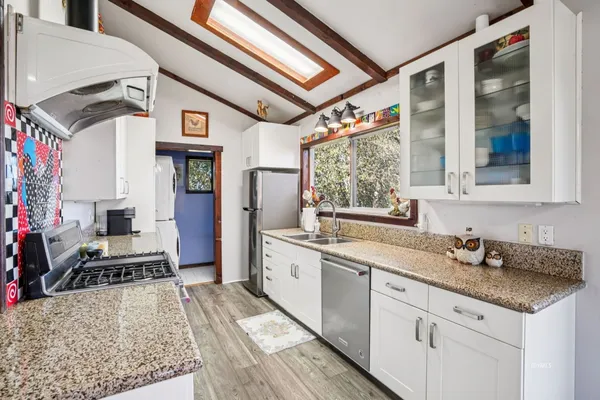 a kitchen with a stove a sink and a refrigerator