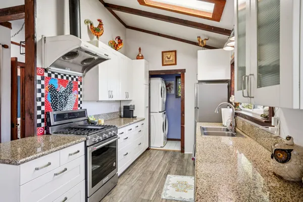 a kitchen with stainless steel appliances granite countertop a stove and a sink