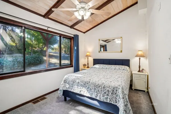 a bedroom with a large bed and a large window