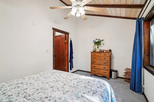 a bedroom with a bed and a dresser in it