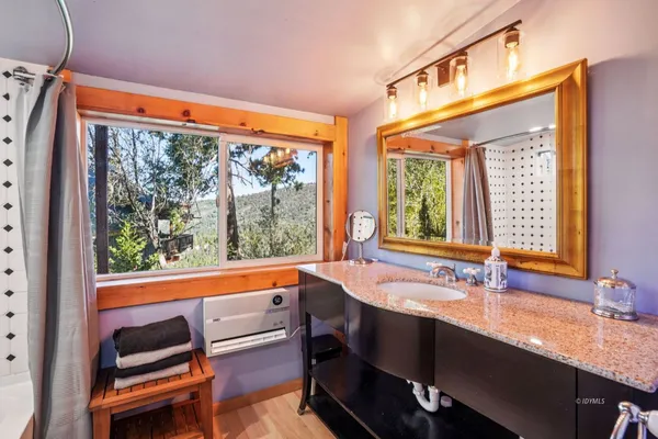 a view of a large kitchen with a sink and cabinets