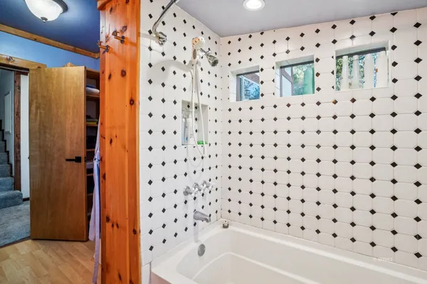 a bathroom with a bathtub and a shower