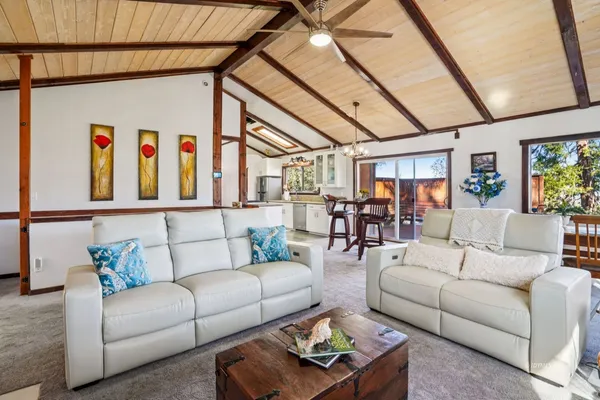 a living room with furniture a couch and a large window