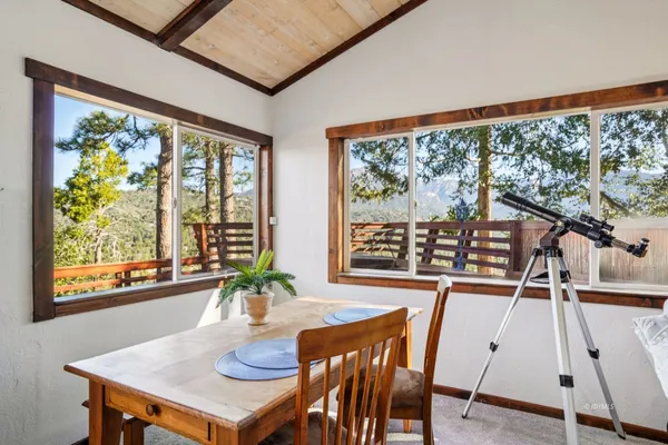 a view of a dining room with furniture window and outside view