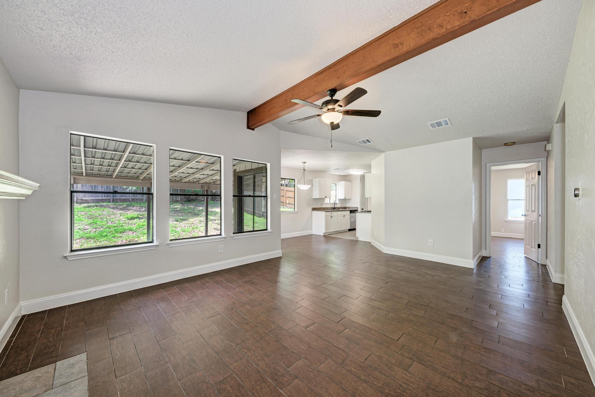 12108 Carnforth Drive Austin, TX 78753 - Photo 7 of 33 a view of a livingroom with wooden floor and a kitchen