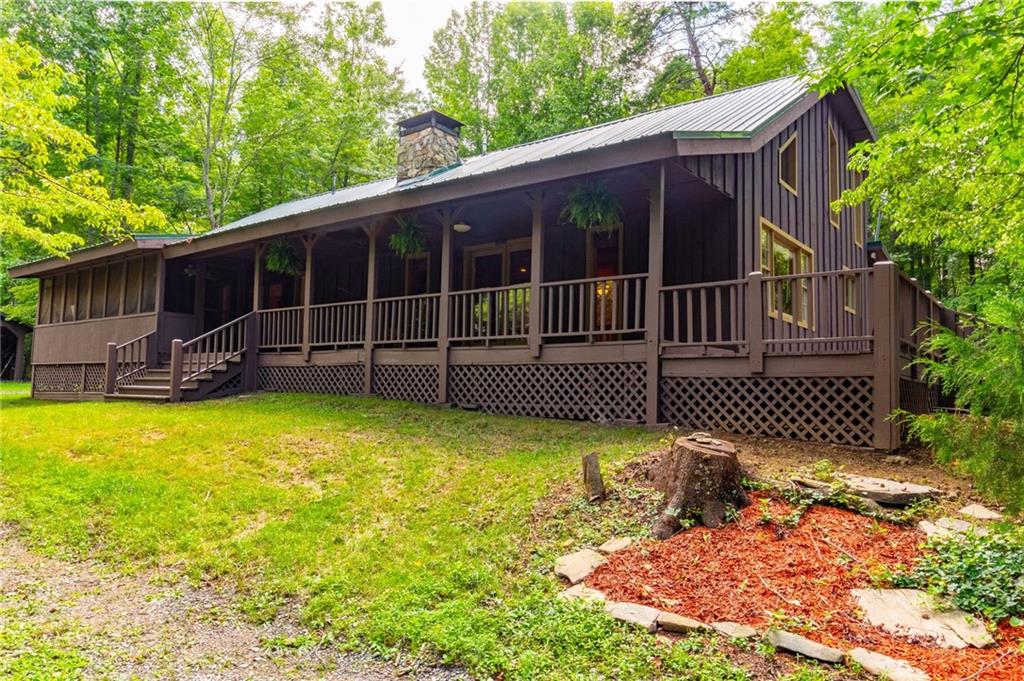 7707 Salacoa Road Waleska, GA 30183 - Photo 1 of 1 a view of a deck with a chair and wooden fence