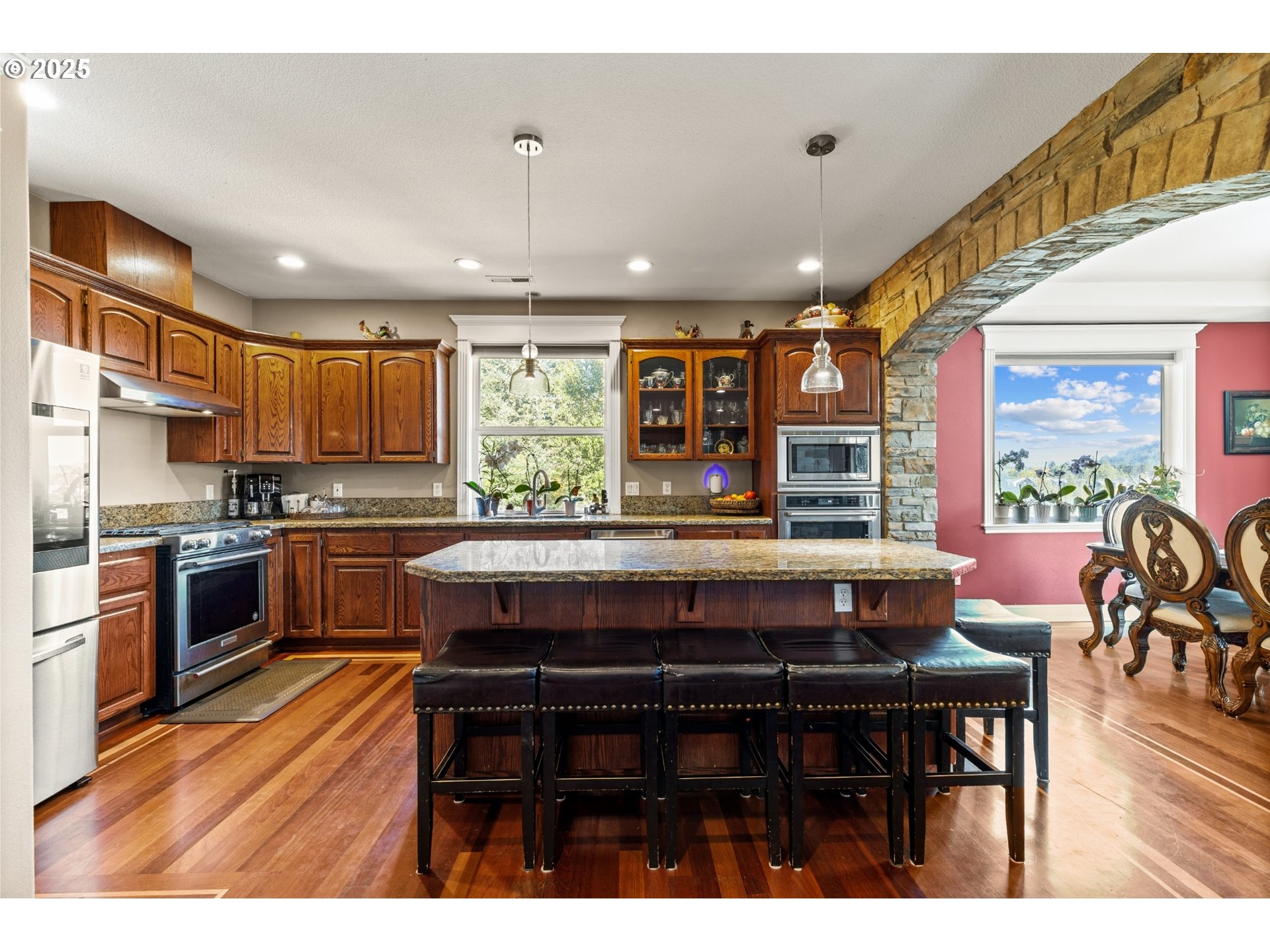 3412 Northwest 1st Street Gresham, OR 97030 - Photo 11 of 40 a kitchen with a table chairs microwave and cabinets