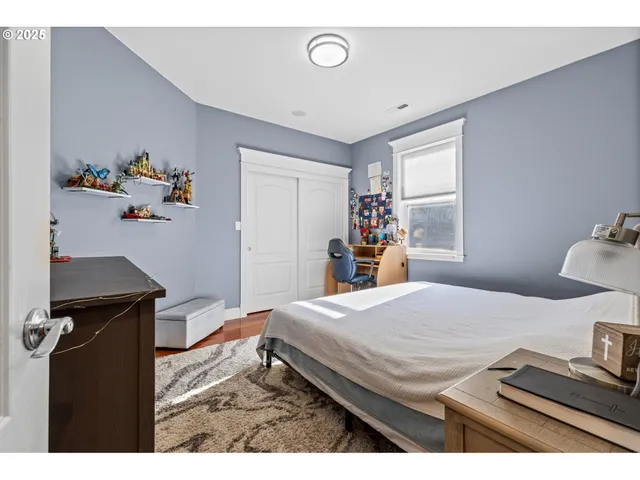 a bedroom with a bed and a dresser