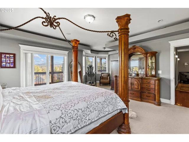 a bedroom with a bed and large mirror with a flat tv screen