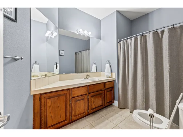 a bathroom with a double vanity sink a mirror and a shower