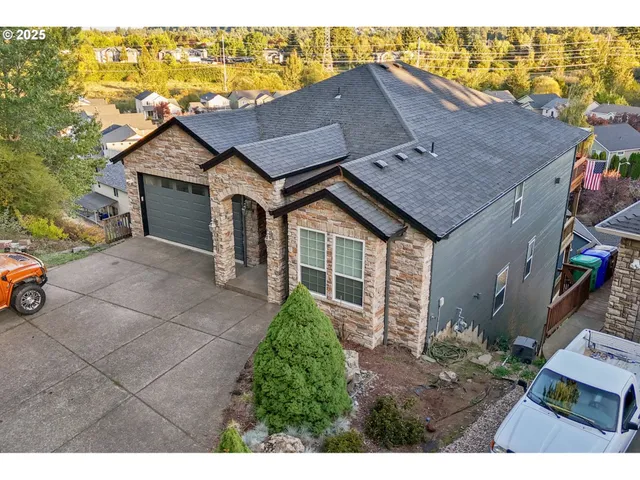 a aerial view of a house next to a yard