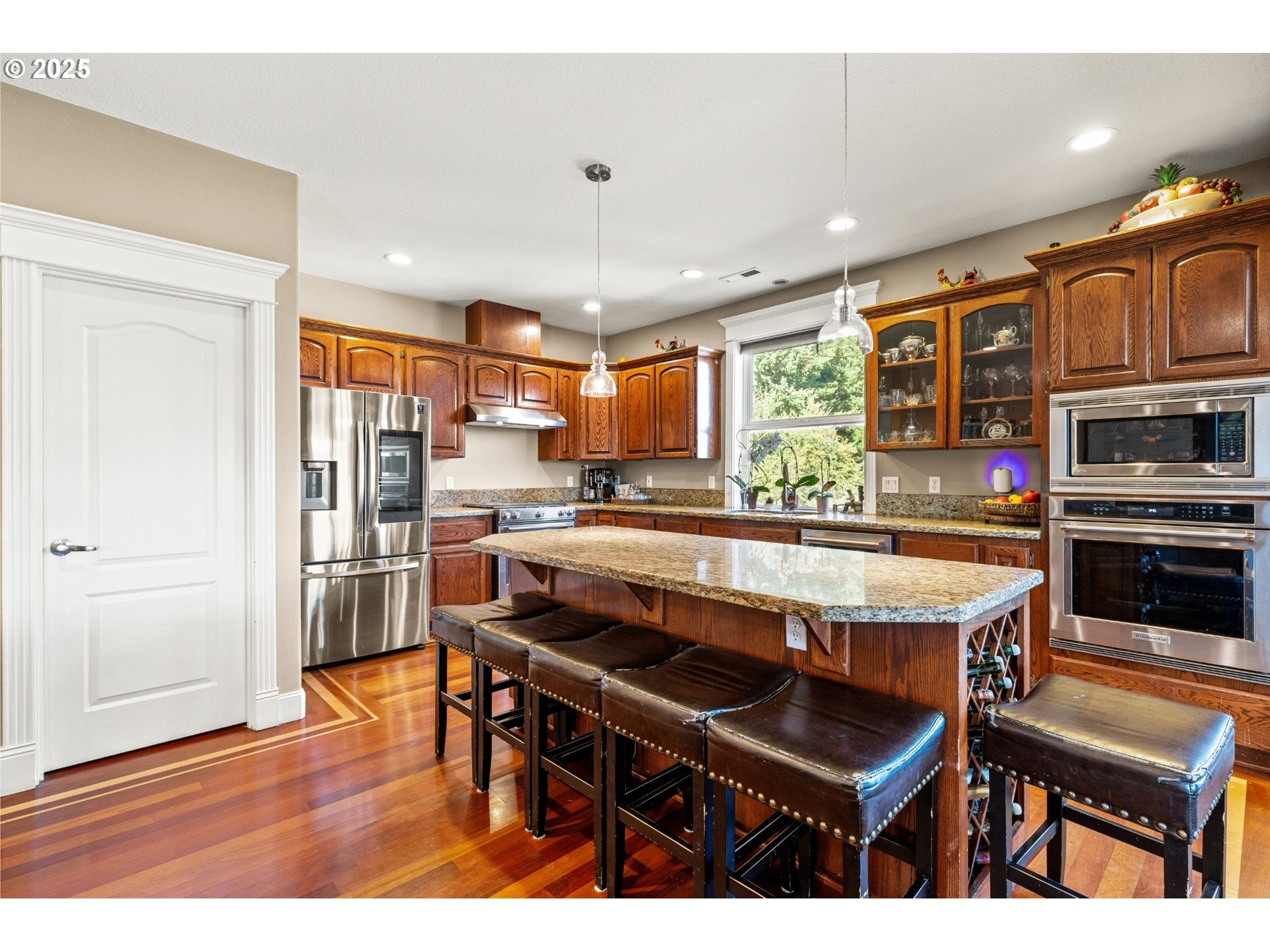 3412 Northwest 1st Street Gresham, OR 97030 - Photo 9 of 40 a kitchen with stainless steel appliances granite countertop a stove and a refrigerator