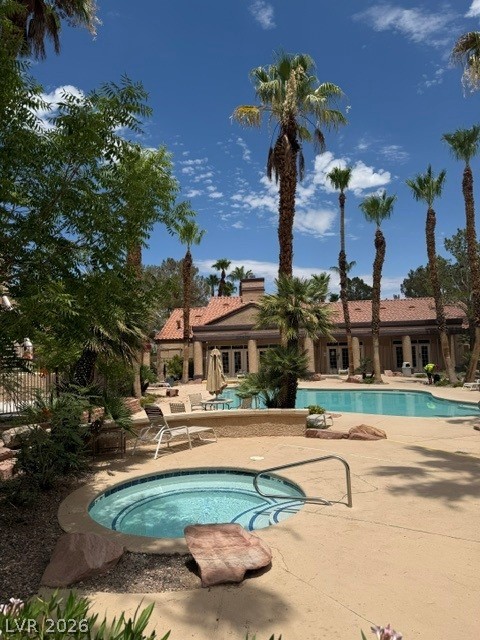 9325 West Desert Inn Road, Unit 278 Las Vegas, NV 89117 - Photo 15 of 17 An inviting spa and sparkling pool await, surrounded by tropical landscaping and a clubhouse.
