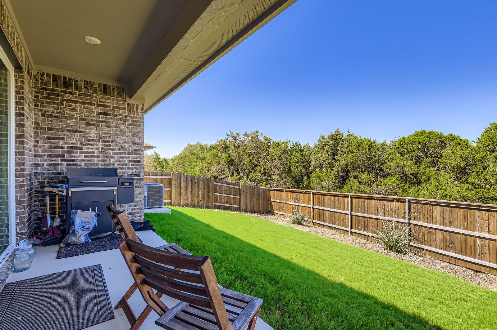 1909 Ruger Pass Leander, TX 78641 - Photo 24 of 31 Fenced backyard with a patio area