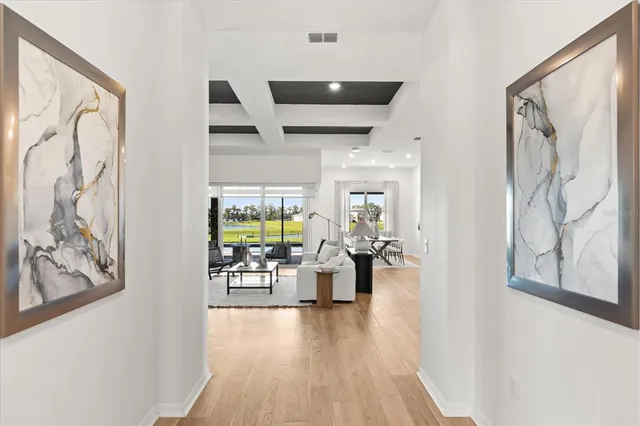 a kitchen with stainless steel appliances kitchen island granite countertop a dining table chairs and granite counter tops