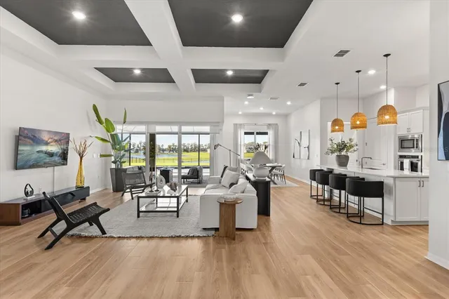 a dining room with furniture and a floor to ceiling window
