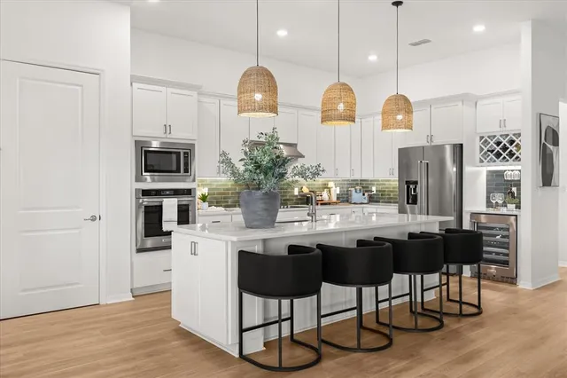 a bathroom with a tub a sink and mirror
