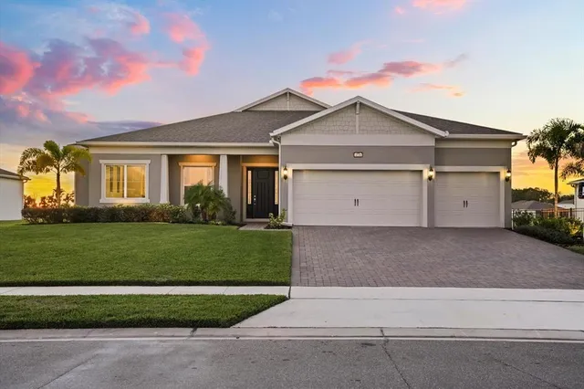 a view of a house with garden and yard